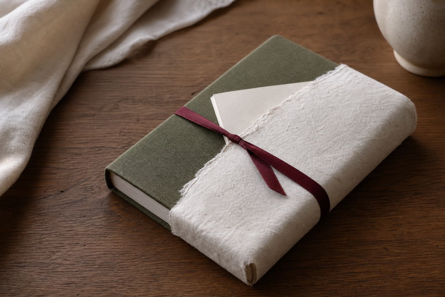 A wrapped clothbound book beside a handwritten note